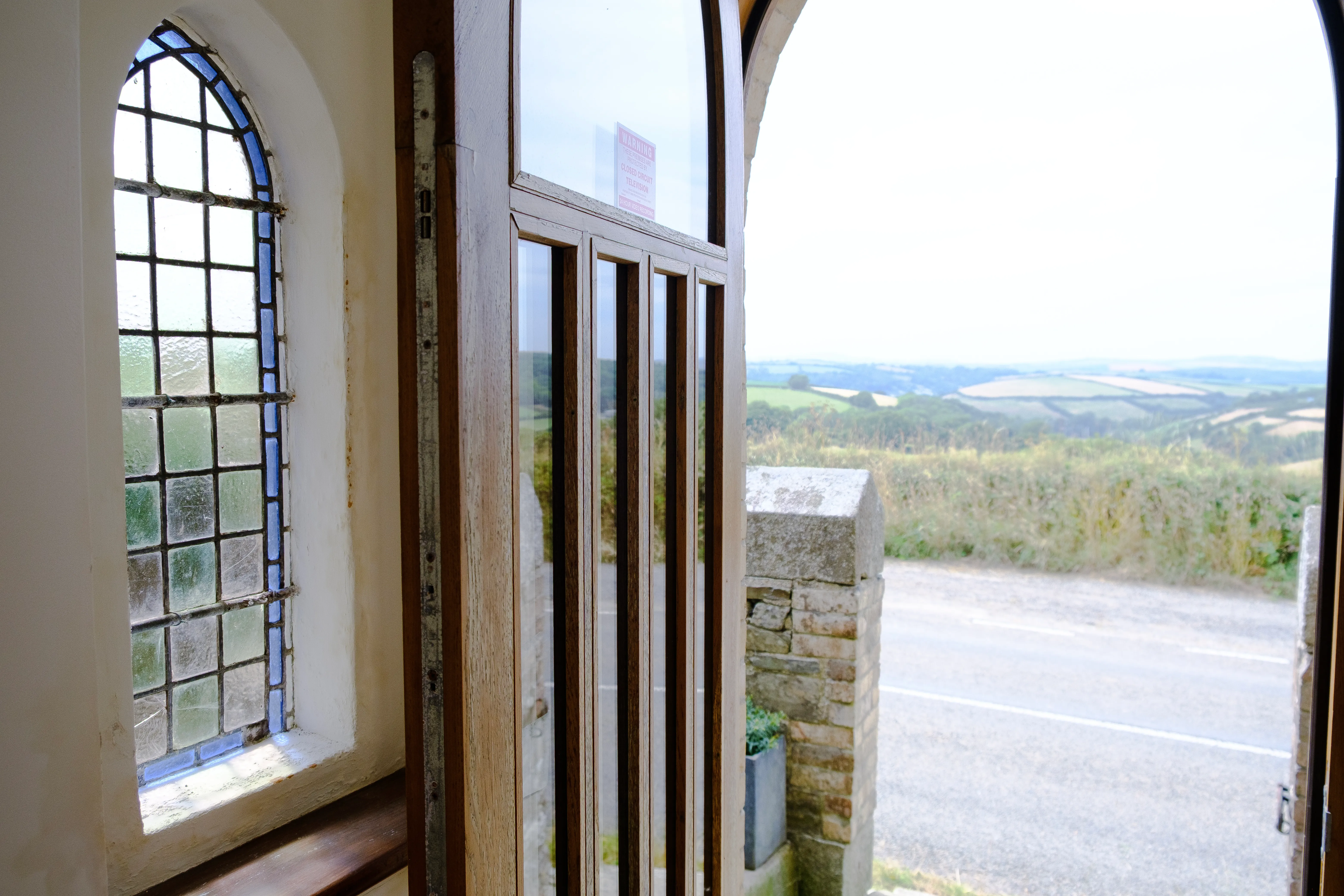 Stained glass in the porch, and the view out of the front door.